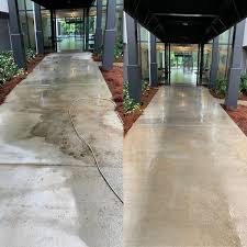 Before and after: Building walkway — pressure wash. Approach walkway to a commercial entrance, cleaned of ground-in soil and staining along its full length.